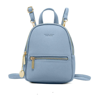 Light blue backpack with gold zippers and accents on a white background