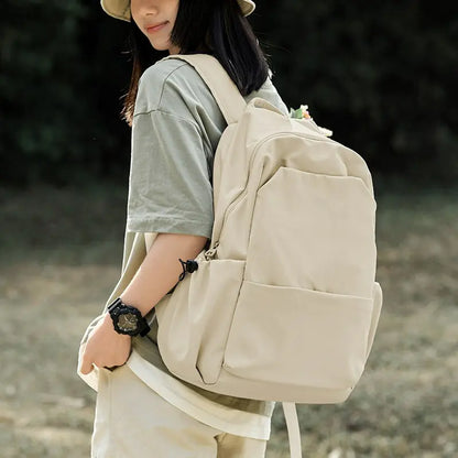 Person wearing a beige backpack outdoors
