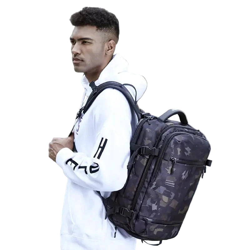Man wearing a large black backpack on a white background