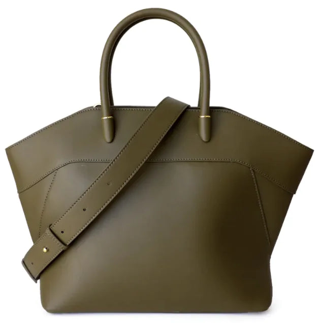 Green leather handbag with a strap on a white background