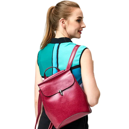 Woman wearing a pink backpack on a plain background