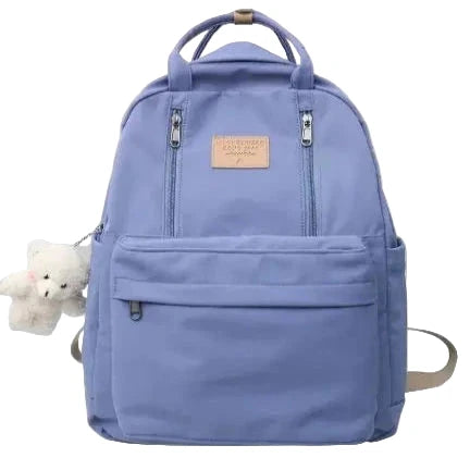 Light blue backpack with a visible brand label on a gray background