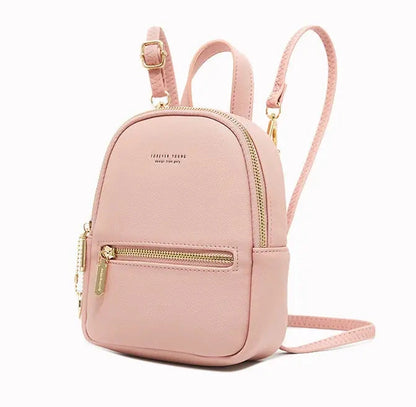 Pink backpack with gold zippers on a white background