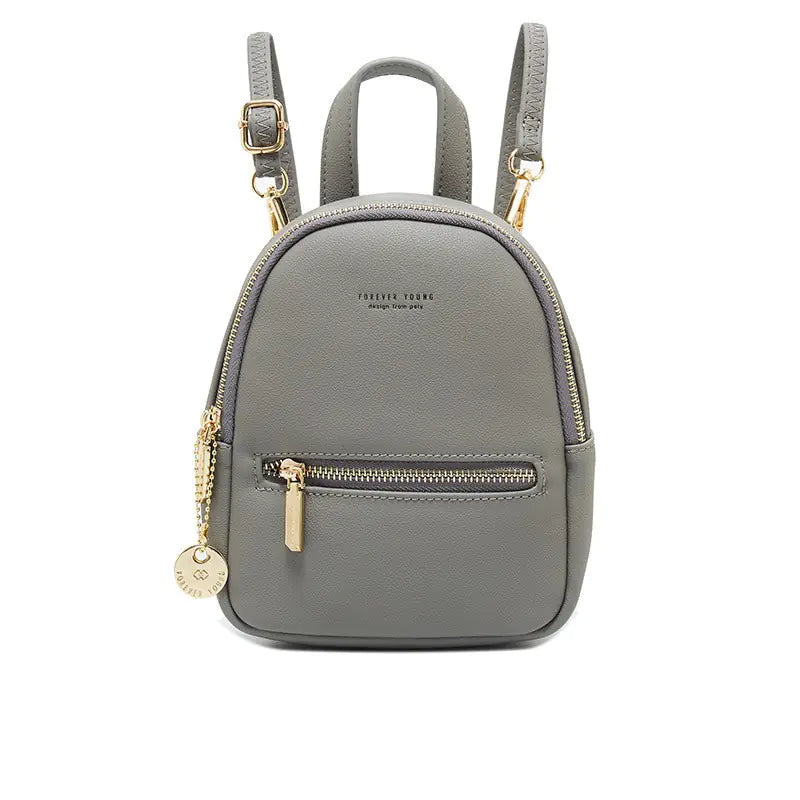 Gray backpack with gold zippers and accents on a white background