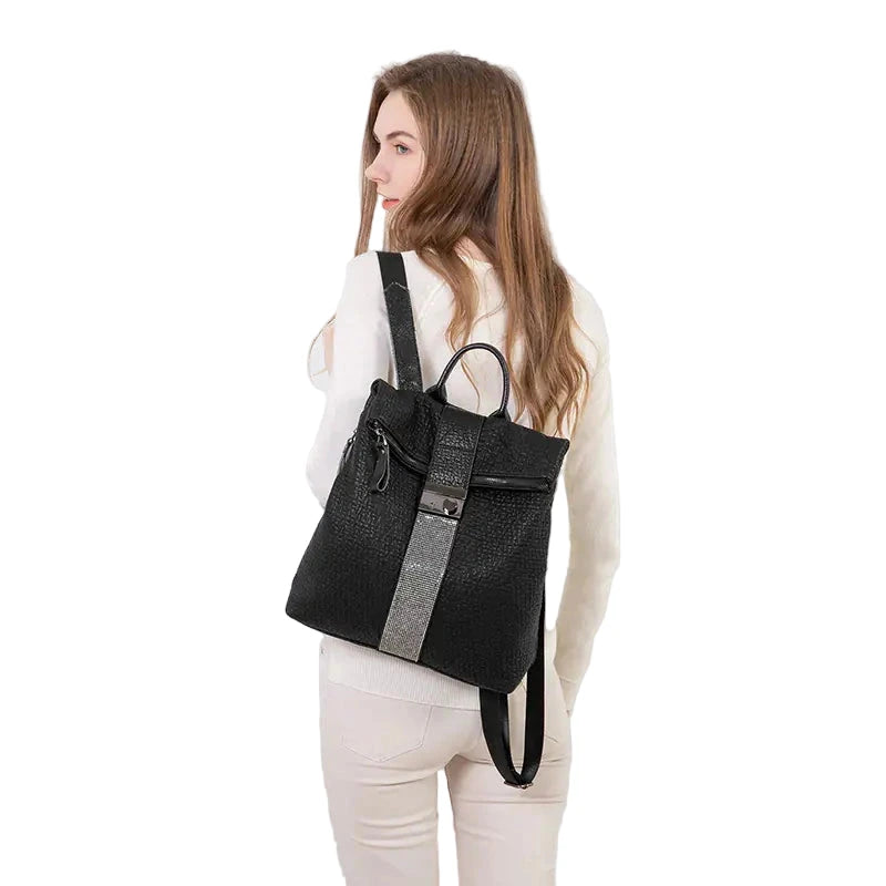 Person wearing a black backpack with gray straps on a white background