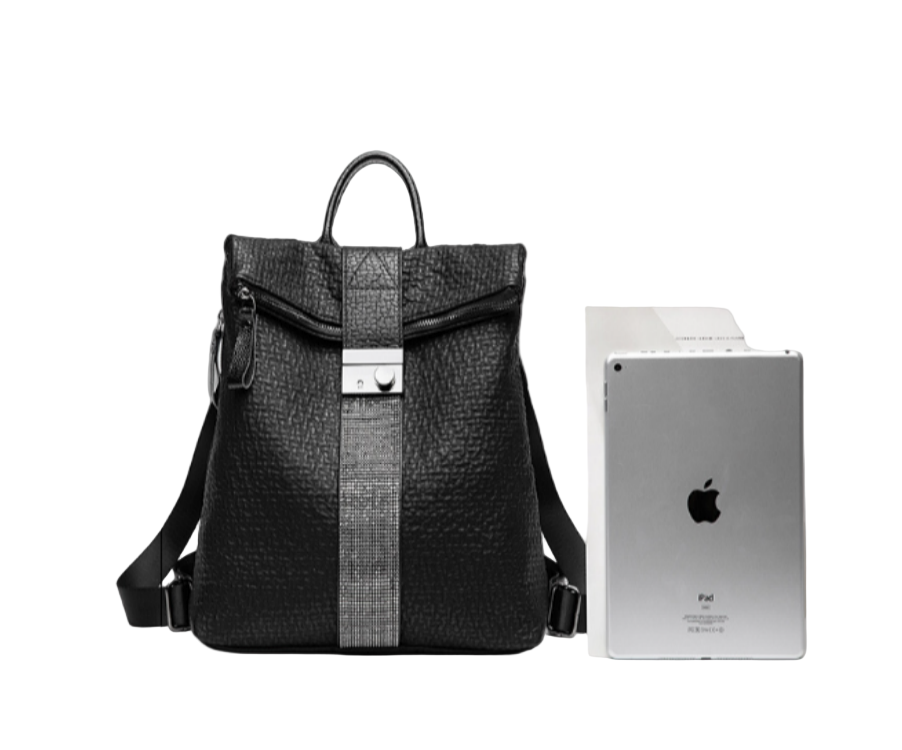 Black Women's leather handbag with iPad against a white background