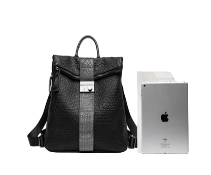Black Women's leather handbag with iPad against a white background