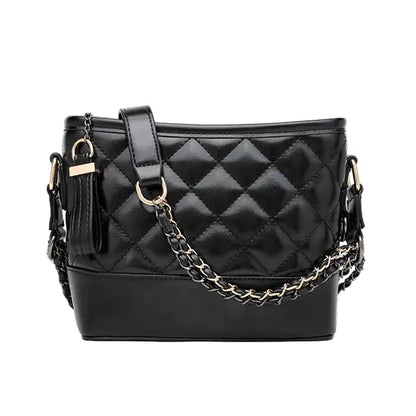 Black quilted handbag with gold chain detail on a white background