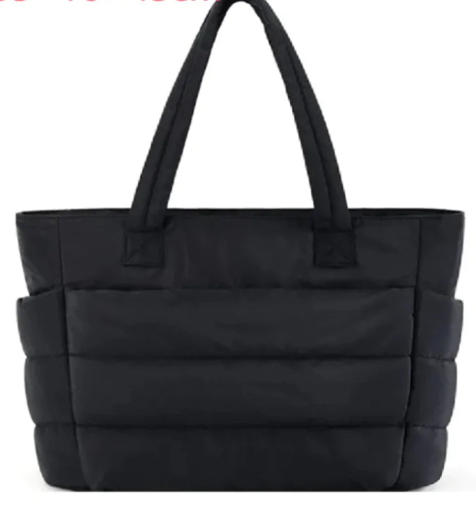 Black quilted tote bag on a white background