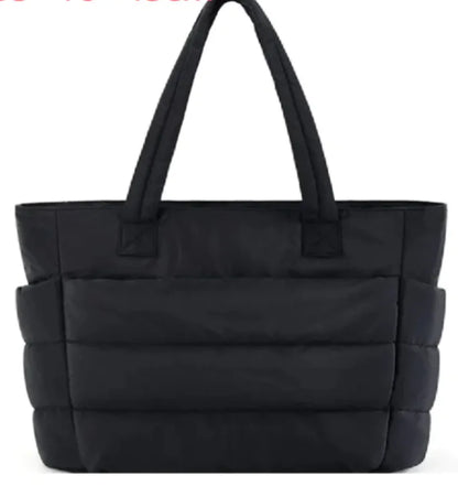 Black quilted tote bag on a white background
