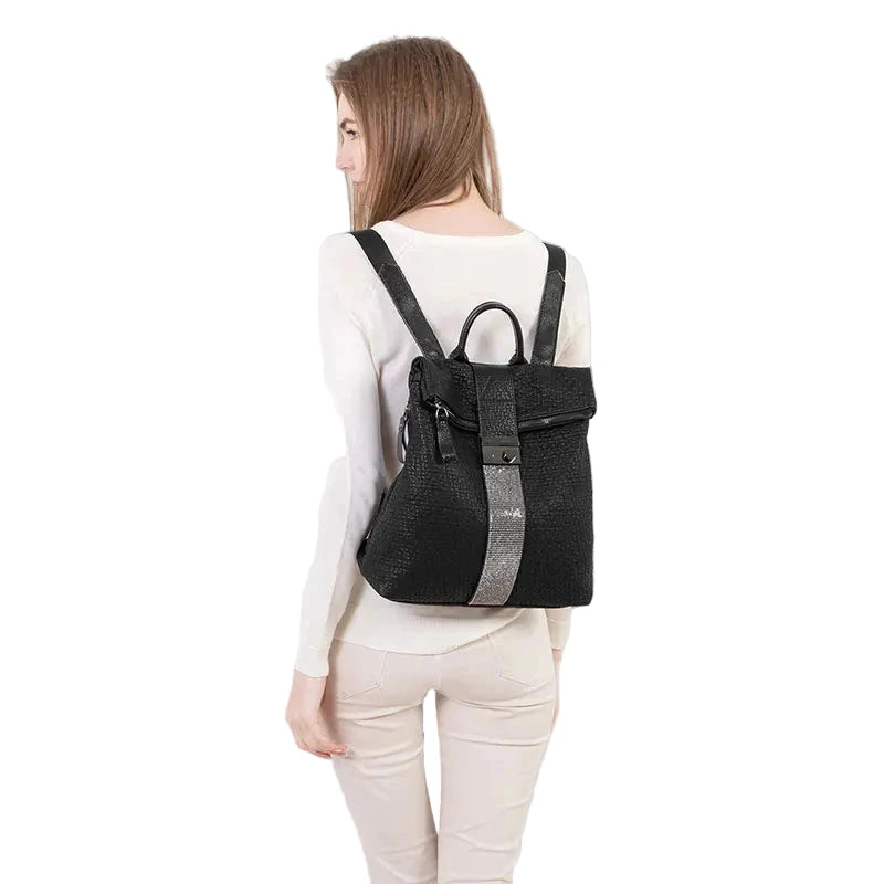 Person wearing a black backpack with gray straps on a white background