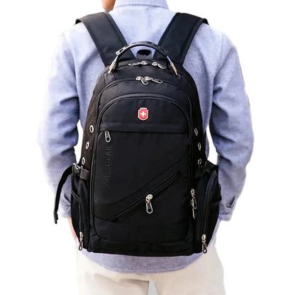 Person wearing a black backpack with a visible brand logo in an urban setting