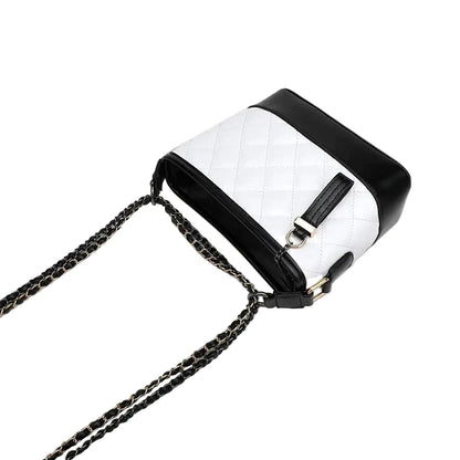White quilted handbag with black accents and chain strap on a white background