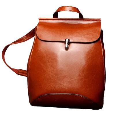 Brown leather backpack on a white background