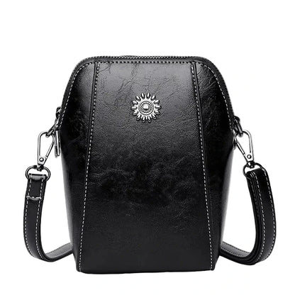 Black leather crossbody bag with a sun emblem on a white background