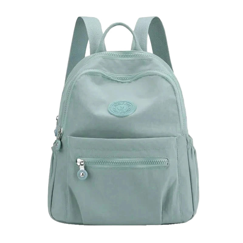 Light blue backpack with a visible brand logo on a white background