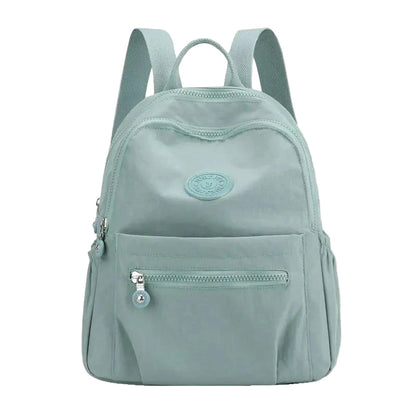Light blue backpack with a visible brand logo on a white background